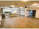 Spacious open floor plan with wood-look tile flooring and a modern kitchen with an island at 26637 S New Town Dr, Sun Lakes, AZ 85248