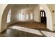Open living space with carpet flooring, arched doorways, and plentiful natural light at 26637 S New Town Dr, Sun Lakes, AZ 85248