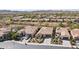 Wide aerial view of homes in a neighborhood, each featuring desert landscaping, tile roofs, and garages at 29588 N 129Th Dr, Peoria, AZ 85383