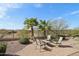 Charming backyard with a paved patio, desert landscaping, and cozy seating area at 29588 N 129Th Dr, Peoria, AZ 85383