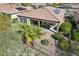 Backyard patio features an outdoor dining area with mature landscaping and desert surroundings at 29588 N 129Th Dr, Peoria, AZ 85383