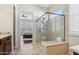 Bathroom including a glass-enclosed shower, tiled floor, and a view into the bedroom at 29588 N 129Th Dr, Peoria, AZ 85383