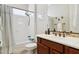 Bathroom featuring a shower and vanity with tile backsplash, with warm neutral tones at 29588 N 129Th Dr, Peoria, AZ 85383