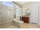 Bathroom with a glass-enclosed shower and a single sink vanity with a tile backsplash at 29588 N 129Th Dr, Peoria, AZ 85383