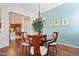 Dining room with hardwood floors and view to the kitchen, featuring a chandelier at 29588 N 129Th Dr, Peoria, AZ 85383