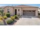 Attractive single-story home featuring a well-maintained front yard with desert landscaping and a two-car garage at 29588 N 129Th Dr, Peoria, AZ 85383