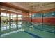 Community indoor lap swimming pool with large windows and brick accent wall at 29588 N 129Th Dr, Peoria, AZ 85383