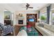 Cozy living room featuring a fireplace, built-in shelves, hardwood floors, and a comfortable sofa at 29588 N 129Th Dr, Peoria, AZ 85383