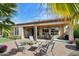 Inviting backyard with a covered patio, multiple seating areas, and picturesque desert landscaping at 29588 N 129Th Dr, Peoria, AZ 85383