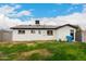 Fenced backyard featuring a grassy area, block fence, and rear house elevation at 3009 W Alice Ave, Phoenix, AZ 85051