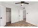 Bright bedroom boasts sleek wood floors, updated fan and fixture, and closet access at 3009 W Alice Ave, Phoenix, AZ 85051