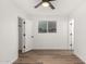 Well-lit bedroom featuring modern flooring, a ceiling fan, closet, and a window at 3009 W Alice Ave, Phoenix, AZ 85051