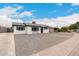 Charming renovated single-story home with crisp white paint, black trim, and xeriscaped yard at 3009 W Alice Ave, Phoenix, AZ 85051