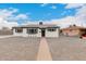 Charming renovated single-story home with crisp white paint, black trim, and xeriscaped yard at 3009 W Alice Ave, Phoenix, AZ 85051