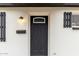 Close up of Front door and entry of renovated single-story home with black trim at 3009 W Alice Ave, Phoenix, AZ 85051