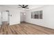 Bright living room features modern flooring, a ceiling fan, and large window at 3009 W Alice Ave, Phoenix, AZ 85051