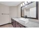 Well-lit bathroom with a single sink, wood vanity, and modern fixtures at 318 E Gail Dr, Gilbert, AZ 85296