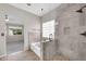 Elegant bathroom with glass shower, soaking tub, and tiled walls at 318 E Gail Dr, Gilbert, AZ 85296