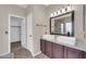 Bathroom with a double sink vanity, large mirror, and tile flooring at 318 E Gail Dr, Gilbert, AZ 85296