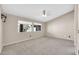 Carpeted bedroom with two windows, a ceiling fan, and neutral wall colors at 318 E Gail Dr, Gilbert, AZ 85296