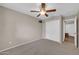 Bedroom featuring a ceiling fan, neutral walls, closet, and carpet at 318 E Gail Dr, Gilbert, AZ 85296