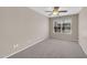 Comfortable bedroom featuring a ceiling fan and a window with blinds at 318 E Gail Dr, Gilbert, AZ 85296