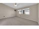 Carpeted bedroom with two windows, a ceiling fan, and neutral wall colors at 318 E Gail Dr, Gilbert, AZ 85296