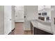 Hallway with hardwood flooring and a view into the kitchen area with modern appliances at 318 E Gail Dr, Gilbert, AZ 85296