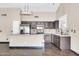 Well-lit kitchen boasting ample countertop space, stainless steel appliances, and dark wood cabinets at 318 E Gail Dr, Gilbert, AZ 85296