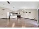 Bright living room with hardwood flooring, ceiling fan, and an open layout to the kitchen at 318 E Gail Dr, Gilbert, AZ 85296