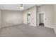 Large carpeted main bedroom with arched doorway, ceiling fan, and neutral colored walls at 318 E Gail Dr, Gilbert, AZ 85296