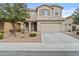 Two-story home featuring a two car garage, neutral colored stucco exterior, and a manicured front yard at 3263 S Miller Dr, Chandler, AZ 85286