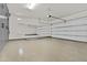 Spacious three car garage with epoxy floor coating, mirror, and built-in storage cabinets at 3263 S Miller Dr, Chandler, AZ 85286