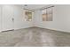 Neutral-toned room featuring tile flooring, two windows with blinds, and a white door in a home's entryway at 3263 S Miller Dr, Chandler, AZ 85286