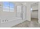 Bright bathroom features a glass shower, large tub, and tile flooring at 3263 S Miller Dr, Chandler, AZ 85286