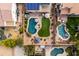 A bird's-eye view of three private pools, lush landscaping, solar panels, and cozy outdoor seating at 3274 E Isaiah Ct, Gilbert, AZ 85298