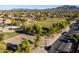 Expansive aerial view showcasing a lush green community park with mountain views at 3274 E Isaiah Ct, Gilbert, AZ 85298