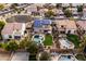 A backyard oasis with solar panels, a pool and hot tub, landscaped yard, and comfortable outdoor seating at 3274 E Isaiah Ct, Gilbert, AZ 85298