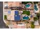 Aerial view showcasing three pools surrounded by beautiful landscaping and solar panels, offering a backyard oasis at 3274 E Isaiah Ct, Gilbert, AZ 85298