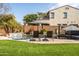 Relaxing backyard featuring a pool with water features, lounge chairs, and well-maintained landscaping at 3274 E Isaiah Ct, Gilbert, AZ 85298