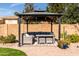 Backyard patio featuring a gazebo with cushioned seating, a table, and a brick-paved area at 3274 E Isaiah Ct, Gilbert, AZ 85298