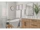 Gorgeous bathroom with a soaking tub next to a large window and a wooden vanity at 3274 E Isaiah Ct, Gilbert, AZ 85298