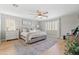 Beautifully staged bedroom with wood floors, neutral colors, ceiling fan and lots of natural light at 3274 E Isaiah Ct, Gilbert, AZ 85298