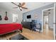 Bedroom with hardwood floors, ceiling fan, desk, and a view of the en-suite bathroom showcasing comfortable and stylish living at 3274 E Isaiah Ct, Gilbert, AZ 85298