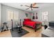 Neutral bedroom featuring hardwood floors, ceiling fan, guitars on wall, and a weightlifting setup for a fitness enthusiast at 3274 E Isaiah Ct, Gilbert, AZ 85298