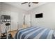 Serene bedroom with wood floors, ceiling fan, and access to an adjacent room, offering a flexible layout at 3274 E Isaiah Ct, Gilbert, AZ 85298