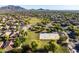 Community aerial view of the basketball court and open green space surrounded by mature trees in a lush, green park at 3274 E Isaiah Ct, Gilbert, AZ 85298