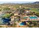 Aerial view of a resort-style community pool and recreation area with water slides, tennis courts and meticulously maintained grounds at 3274 E Isaiah Ct, Gilbert, AZ 85298