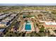 Aerial view of the neighborhood pool featuring a lap pool, lounge chairs, mature landscaping and tennis courts at 3274 E Isaiah Ct, Gilbert, AZ 85298