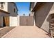 Paver driveway between homes leads to backyard gate and landscaping at 3274 E Isaiah Ct, Gilbert, AZ 85298